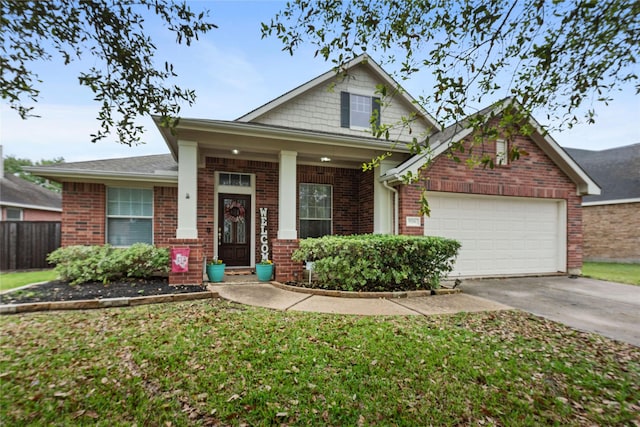 craftsman inspired home featuring a garage and a front lawn