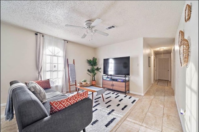 tiled living room featuring a textured ceiling and ceiling fan