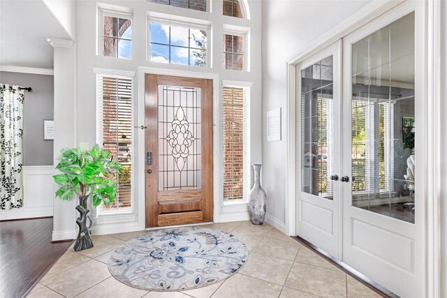 16211 Florida View Ln, Houston, TX 77044 - entryway with crown molding, light tile patterned flooring, a high ceiling, and french doors
