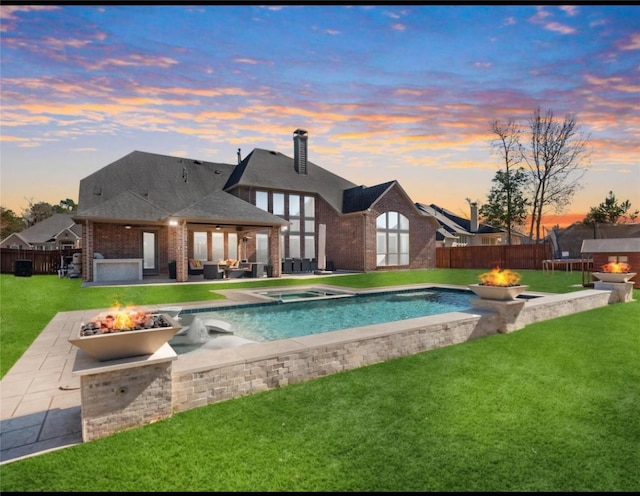 16211 Florida View Ln, Houston, TX 77044 - pool at dusk featuring an outdoor fire pit, a patio area, and a fenced backyard