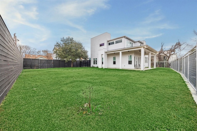 rear view of property featuring a lawn