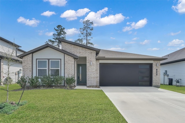 view of front of house featuring a garage and a front lawn