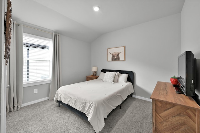 carpeted bedroom with lofted ceiling