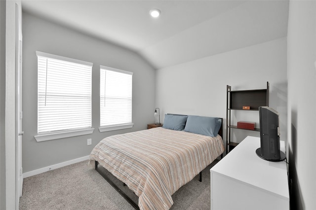 bedroom with light colored carpet and lofted ceiling