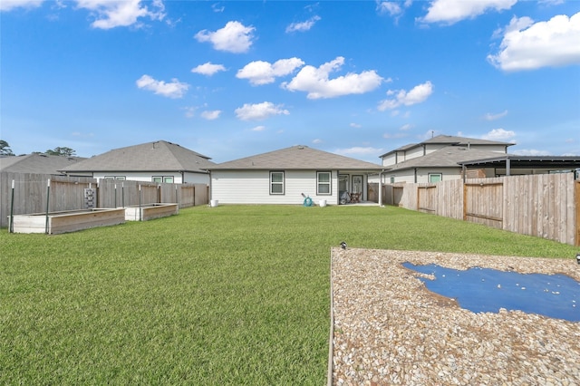 rear view of house with a lawn