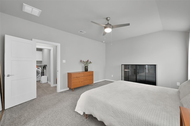 bedroom featuring ceiling fan, lofted ceiling, washer / dryer, and carpet floors