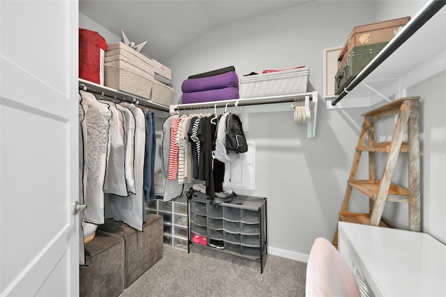 spacious closet featuring carpet flooring and vaulted ceiling