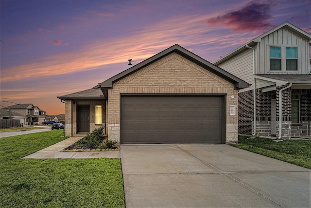 view of front of house featuring a garage and a lawn