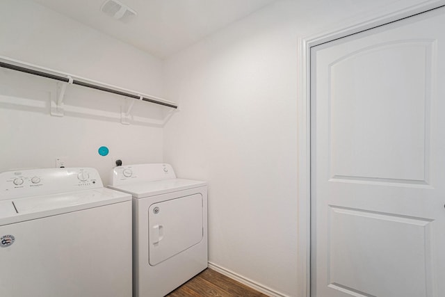 laundry room with dark hardwood / wood-style floors and washing machine and clothes dryer