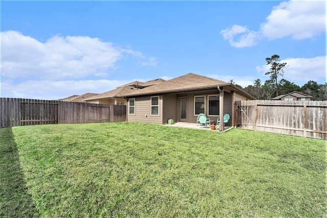 rear view of house featuring a yard and a patio