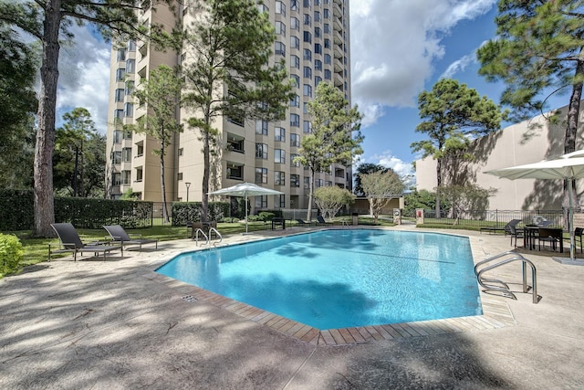 view of swimming pool featuring a patio area