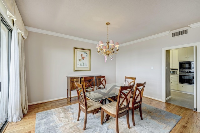 dining room featuring crown molding, an inviting chandelier, and light hardwood / wood-style flooring