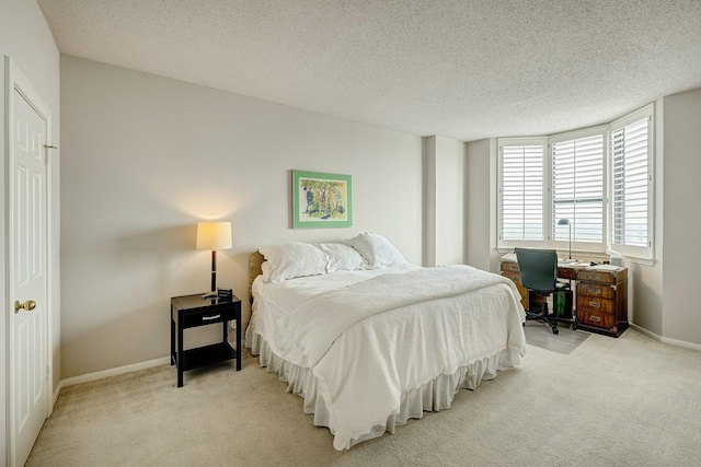 carpeted bedroom featuring a textured ceiling