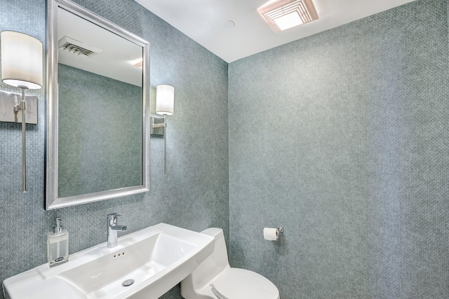 bathroom featuring sink and toilet