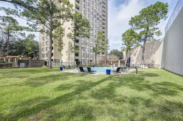 view of community featuring a community pool, a lawn, and central air condition unit