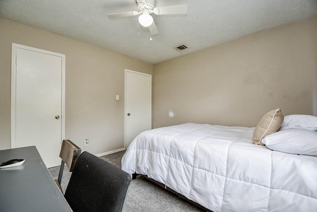 carpeted bedroom with a ceiling fan, baseboards, visible vents, and a textured ceiling