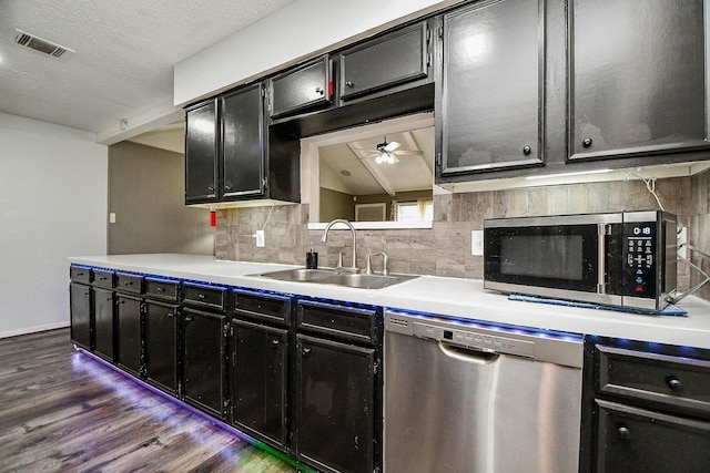 kitchen featuring visible vents, stainless steel appliances, a sink, and light countertops