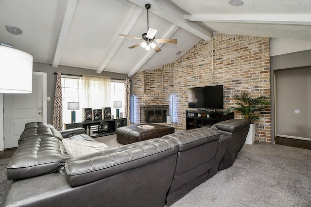 living room with vaulted ceiling with beams, ceiling fan, brick wall, a fireplace, and carpet flooring