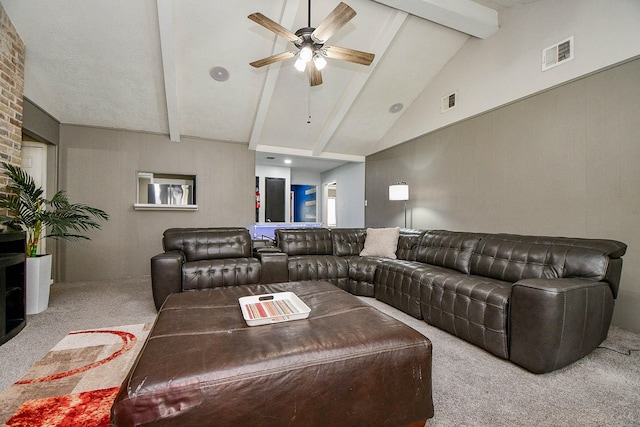 carpeted living room featuring ceiling fan, visible vents, and beam ceiling