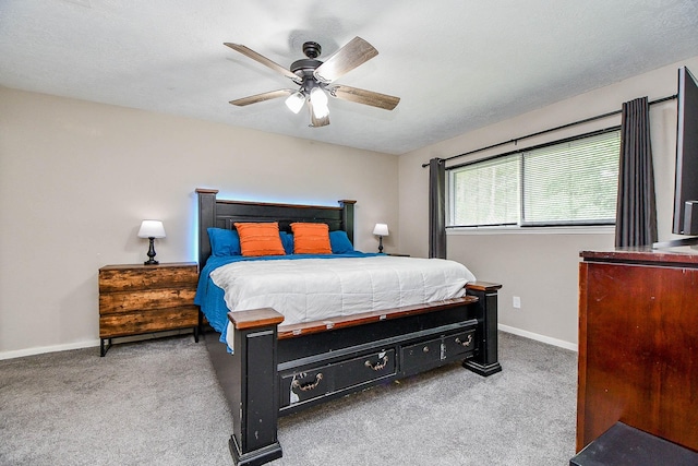 carpeted bedroom with a ceiling fan and baseboards