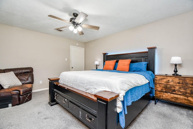 bedroom with a textured ceiling, baseboards, a ceiling fan, and light colored carpet