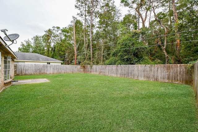 view of yard with a fenced backyard