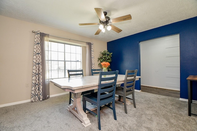 dining space with carpet floors, a ceiling fan, baseboards, and a textured ceiling