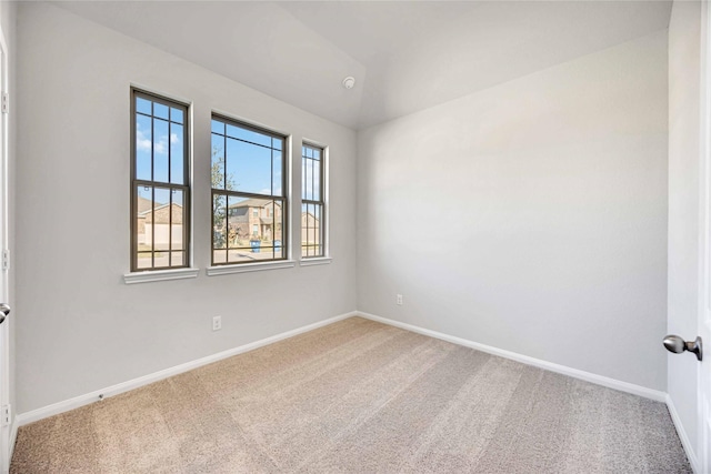 spare room with lofted ceiling and carpet