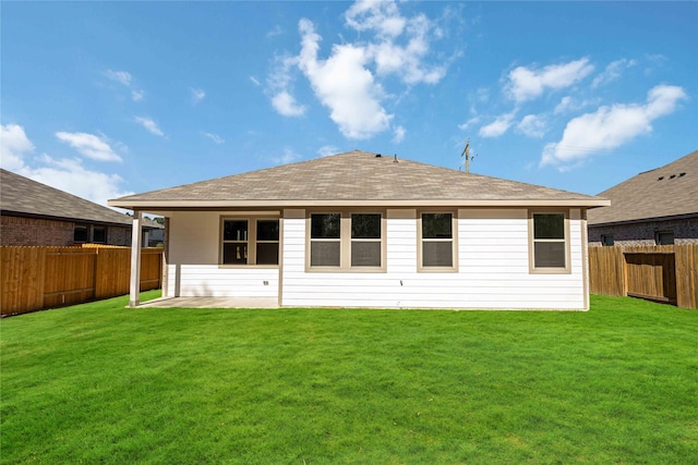 rear view of house featuring a yard and a patio area