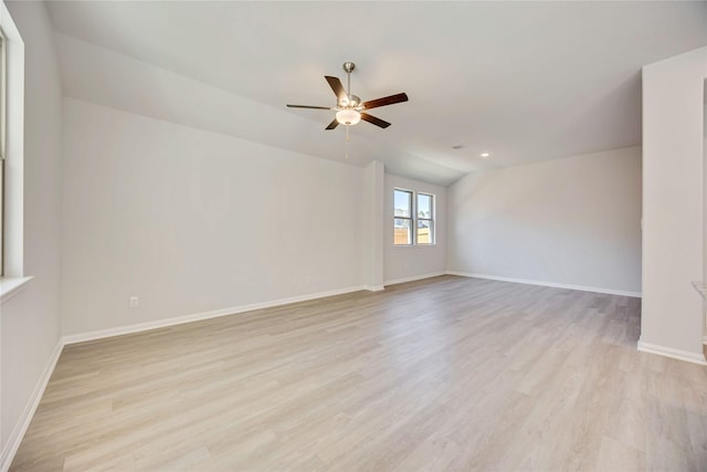 unfurnished room featuring ceiling fan, lofted ceiling, and light hardwood / wood-style floors