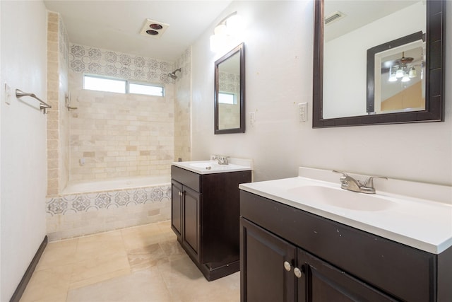 bathroom with vanity, tiled shower / bath combo, and tile patterned floors