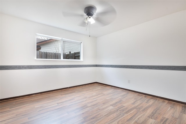 unfurnished room with hardwood / wood-style floors and ceiling fan