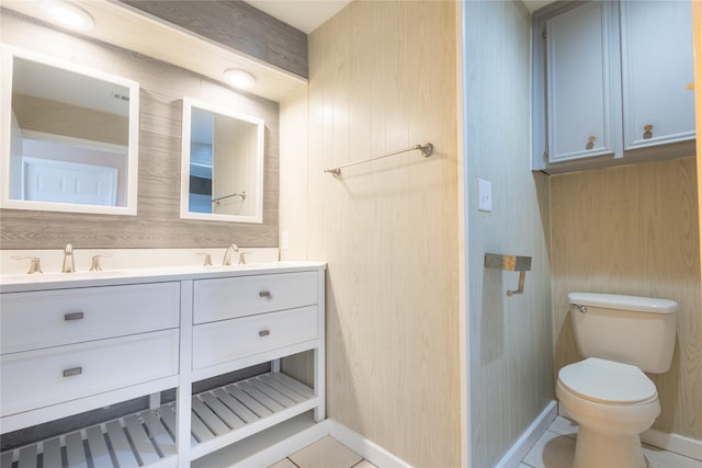 bathroom with vanity, tile patterned flooring, and toilet