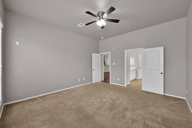 unfurnished bedroom featuring ceiling fan and light carpet