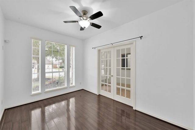 unfurnished room with dark wood-type flooring, french doors, and ceiling fan