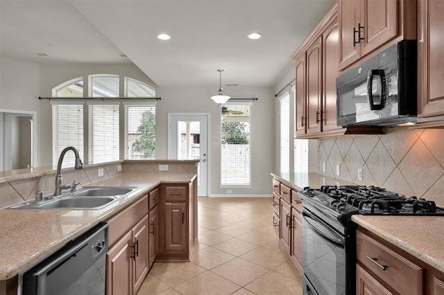 kitchen with light tile patterned flooring, sink, black appliances, pendant lighting, and backsplash