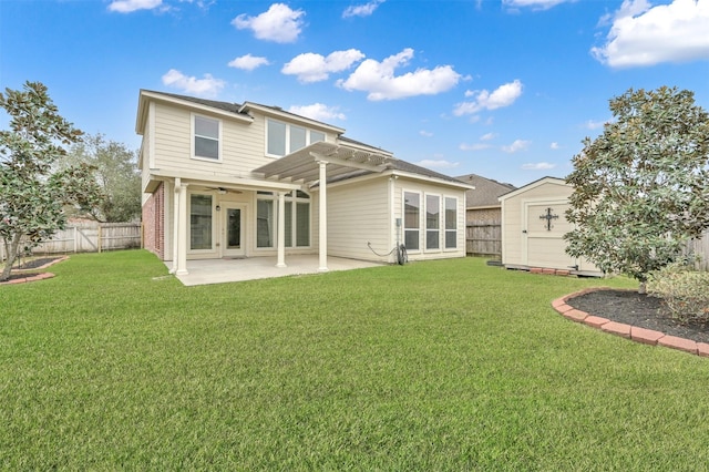 rear view of house featuring a yard, a patio area, and a storage unit