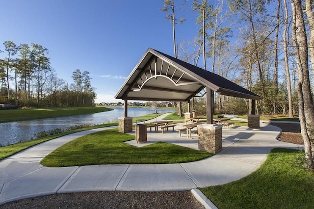 view of community featuring a water view, a yard, and a gazebo