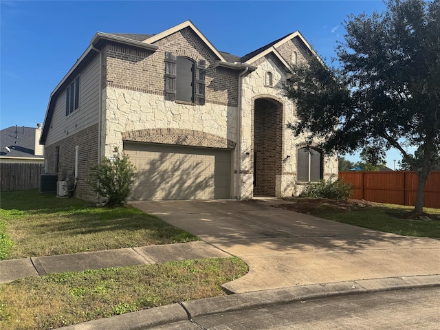 view of front of house with a garage and a front lawn