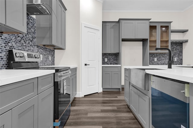 kitchen with gray cabinetry, crown molding, stainless steel range with electric stovetop, dark hardwood / wood-style floors, and wall chimney range hood