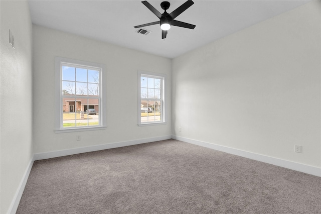 carpeted spare room featuring ceiling fan