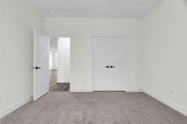 unfurnished bedroom featuring a closet and carpet