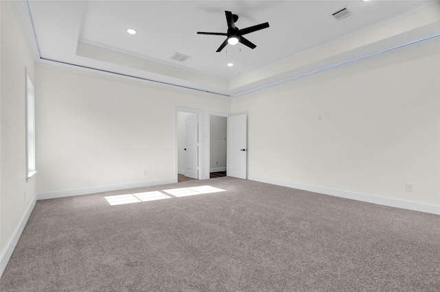 unfurnished room with carpet flooring, ceiling fan, and a tray ceiling