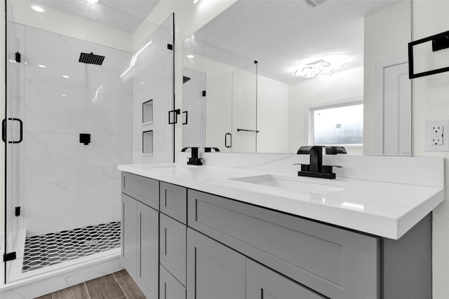 bathroom with walk in shower and vanity