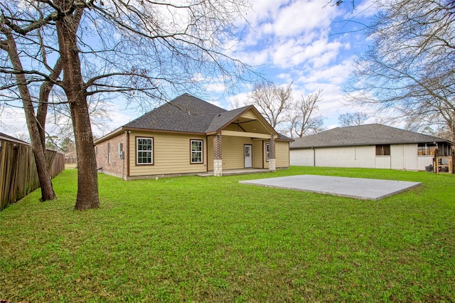 rear view of house with a yard and a patio area