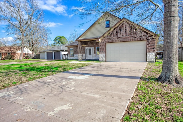 17518 Monsoon Ct, Crosby, TX 77532 - traditional-style home with brick siding, a garage, a front lawn, concrete driveway, and stone siding