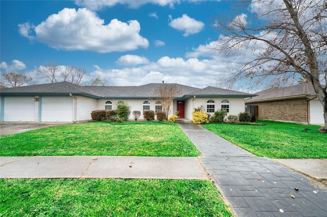 ranch-style home with a garage and a front lawn