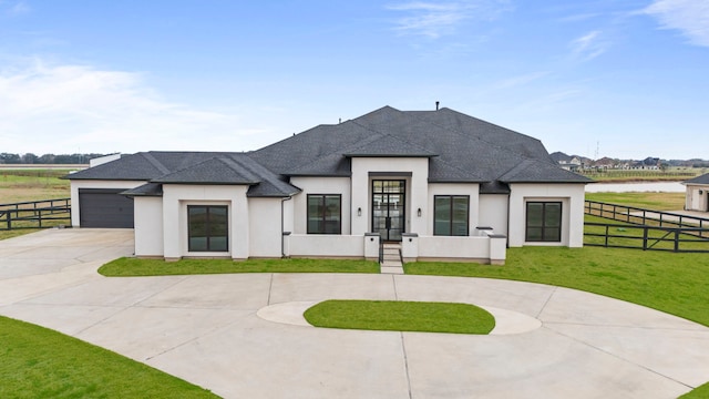 view of front of house featuring a garage, a water view, and a front lawn