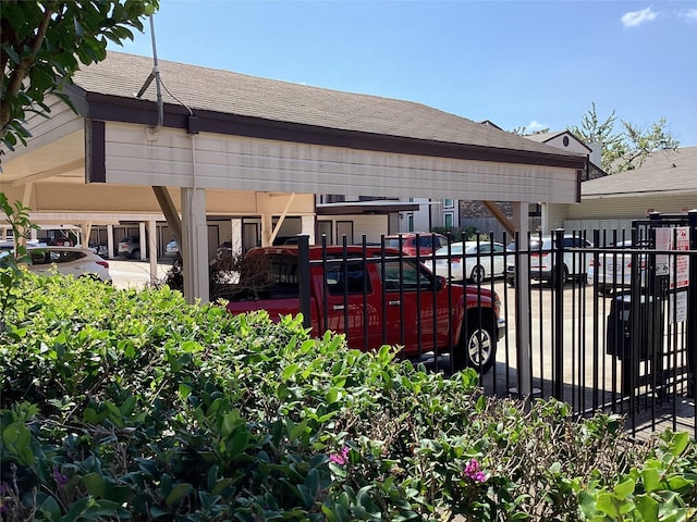 rear view of house with fence and roof with shingles