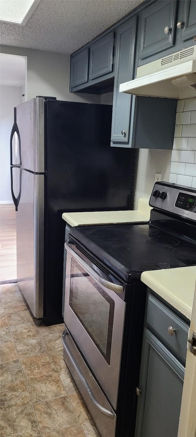 kitchen featuring gray cabinets, stainless steel range with electric cooktop, light countertops, under cabinet range hood, and a textured ceiling